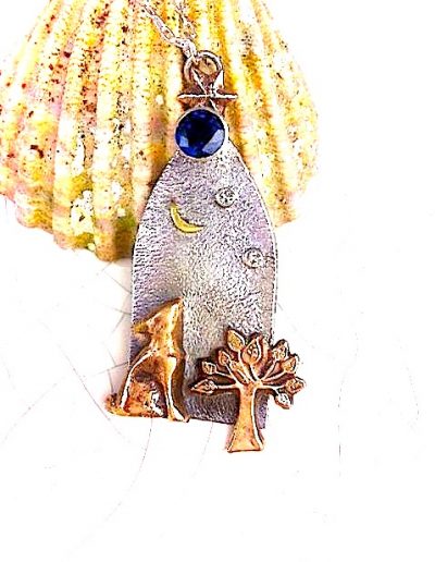 A moon gazy hare necklace with a sapphire